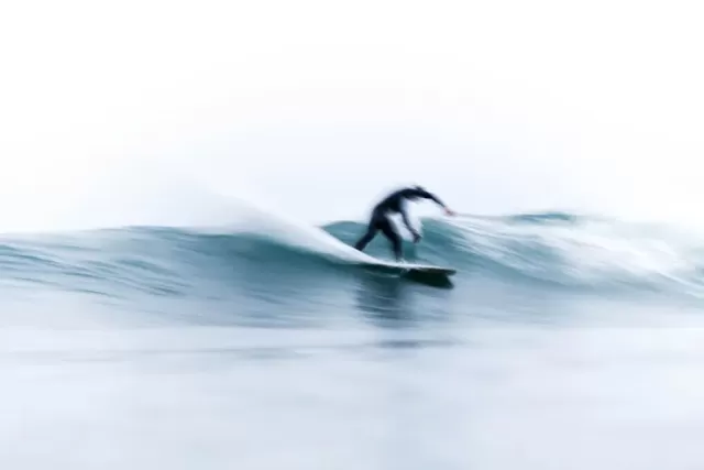 Blurred surfer on the waves